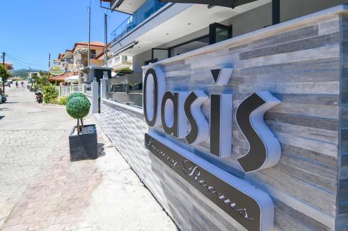 a sign for a store on the side of a building at Oasis in Sarti