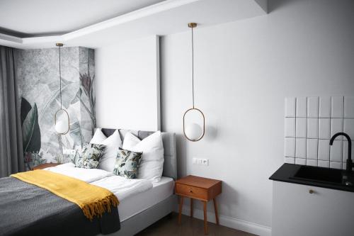a bedroom with a bed with two lights on it at Zielony Dom in Mielno