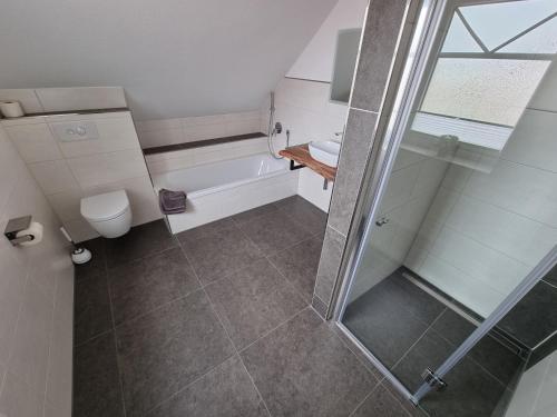 een badkamer met een douche en een toilet bij Frischer Wind in Neuharlingersiel