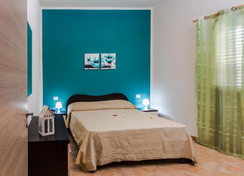 Postel nebo postele na pokoji v ubytování Casa vacanze Biondo