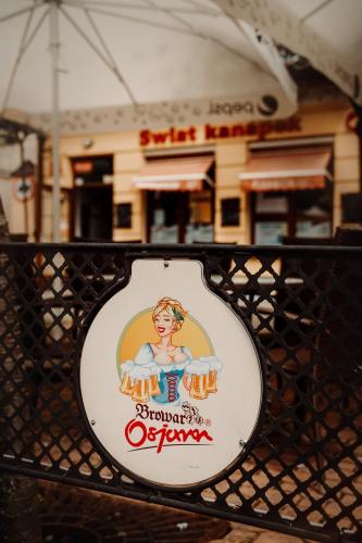 a sign on a fence in front of a building at Hotel Osjann in Biała Podlaska