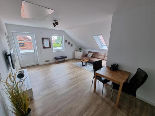 a living room with a table and a couch at Frischer Wind in Neuharlingersiel