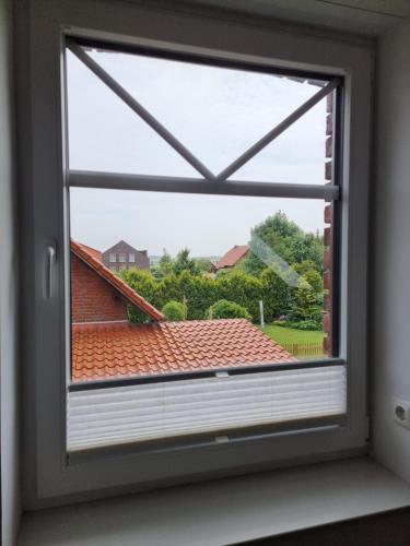 a window with a view of a roof at Frischer Wind in Neuharlingersiel