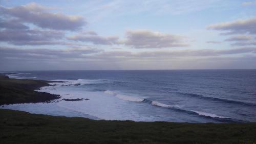 an aerial view of the ocean on a cloudy day at Cabañas Te Maori in Hanga Roa