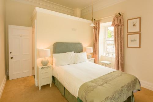 a bedroom with a bed and a window at Springkell in Eaglesfield