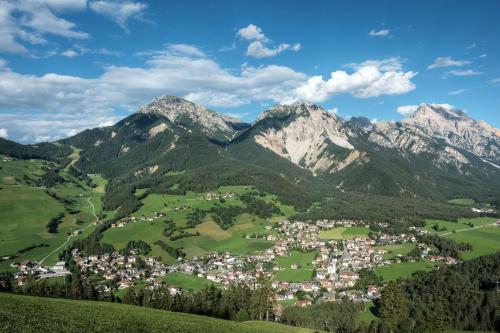 a town in a valley with mountains in the background at Pescosta Chalet Luxury Living in San Vigilio Di Marebbe