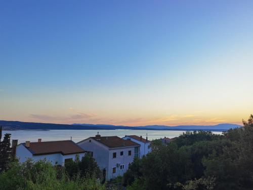 a group of buildings on a hill with a sunset at Apartment PEK in Crikvenica
