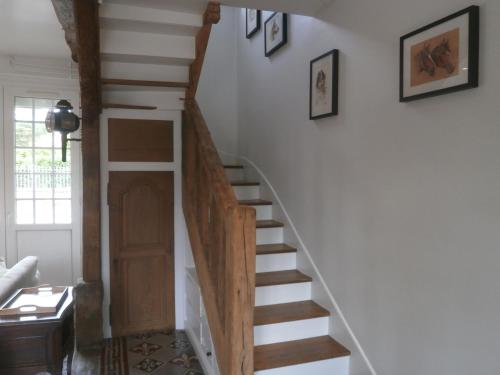 a staircase in a home with white walls at AU CLAIRE DE LUNE in Le Bourg-Dun