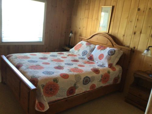 a bedroom with a bed with a floral comforter at Trinity Suites in Trinity