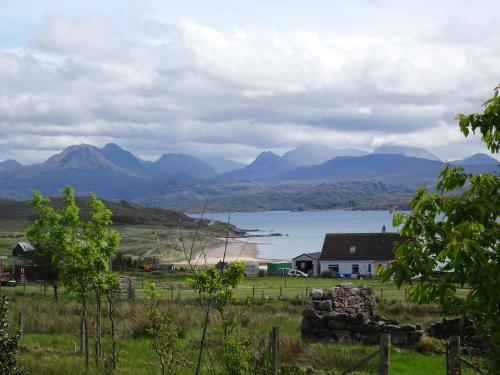 a view of a house and a lake and mountains at Asgard in Big Sand