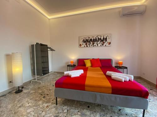 a bedroom with a bed with a colorful blanket at Cutapp Guest House in Catania