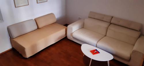 a living room with a couch and a table at Apartment Vladka PARK in Izola