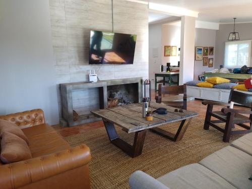 a living room with a table and a fireplace at La Cañada in Minas