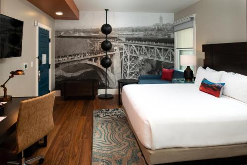 a hotel room with a bed and a mural of the eiffel tower at Hotel Indigo Spokane Downtown by IHG in Spokane