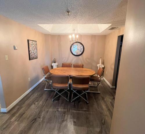 a dining room with a table and chairs and a clock at Sugar Top 2805 Condo in Sugar Mountain