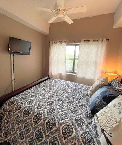 a woman laying on a bed in a bedroom at Sugar Top 2805 Condo in Sugar Mountain