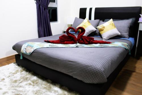 a bed with two red towels on top of it at MLH Premier Suites @ Saville Cheras in Cheras