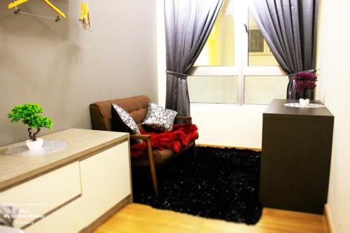 a living room with a couch and a window at MLH Premier Suites @ Saville Cheras in Cheras