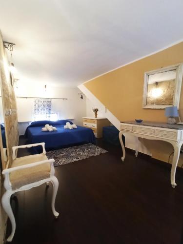 a bedroom with a bed and a desk and a chair at Casa Liò in Santa Flavia