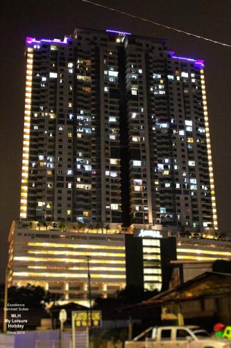 a large building with purple lights on it at night at MLH Premier Suites @ Saville Cheras in Cheras