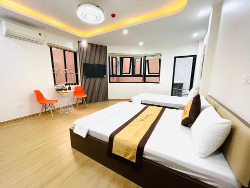 a hotel room with two beds and a table at A&EM VILLA in Hanoi