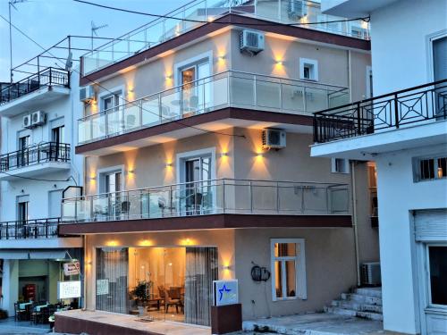 a building with balconies and lights on it at Star Bay Luxury in Limenaria