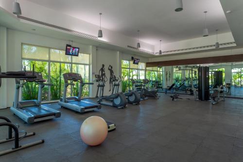 a gym with a lot of treadmills and machines at Mareazul Beach Front Condos At playa del Carmen in Playa del Carmen