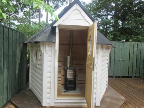 a large white dog house on a deck at DogrunCafe & Resorts JENNIE West-Karuizawa in Miyota