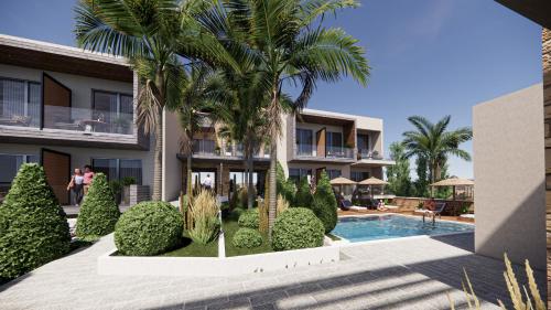 ein Resort mit einem Pool und Palmen in der Unterkunft Soho Exclusive Suites in Skala Potamias