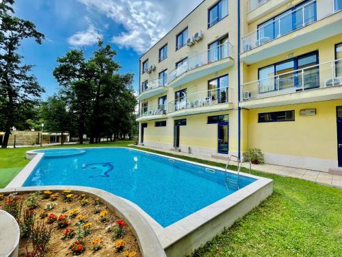 a swimming pool in front of a building at Solei Apartments in Primorsko