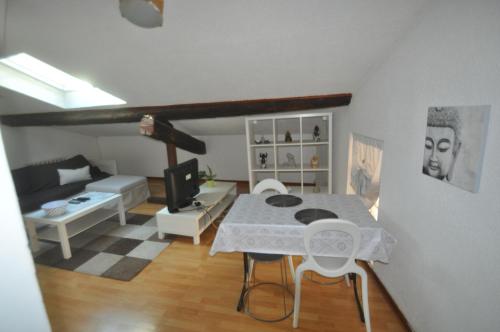 uma sala de estar com uma mesa e um sofá em sassenage au pied du Vercors 2 appartements em Sassenage