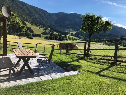 a picnic table and chairs next to a fence at Nagerhof in Gnesau