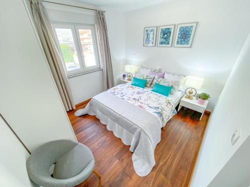 a bedroom with a bed with blue pillows and a window at Apartment Josipa in Split