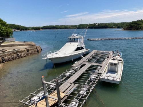 two boats are docked at a dock in the water at Yadokari Shima in Shima