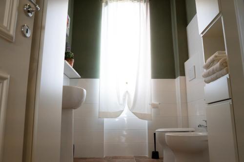 a bathroom with a toilet and a window at PODERE IL QUADRO in Lamporecchio