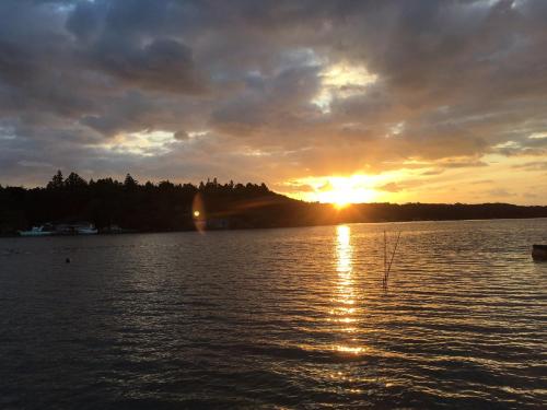 a sunset over a large body of water at Yadokari Shima in Shima