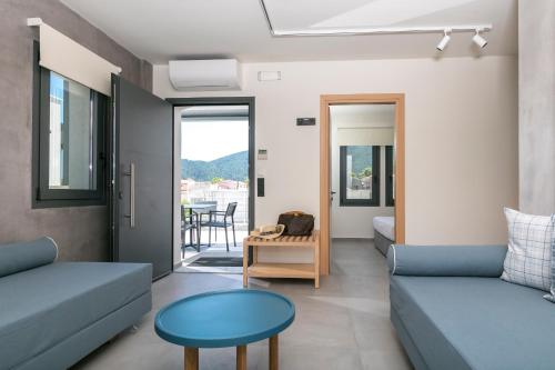 a living room with a couch and a table at Marajo Suites in Skala Potamias