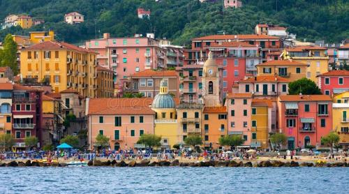 a group of people standing on a beach near the water at Atena in La Spezia