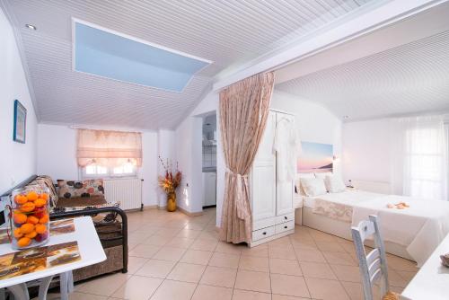 a large room with a bed and a table at Studios Kira Veta in Potos