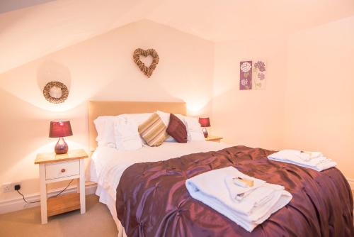 a bedroom with a bed with a heart on the wall at Springkell in Eaglesfield
