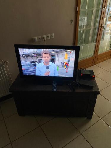 a flat screen tv sitting on top of a table at Maison 6 personnes La Tourelle in Saulchoy