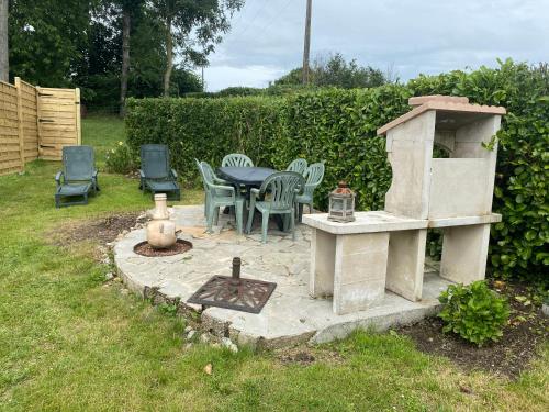 a patio with a table and chairs and a fireplace at Maison 6 personnes La Tourelle in Saulchoy