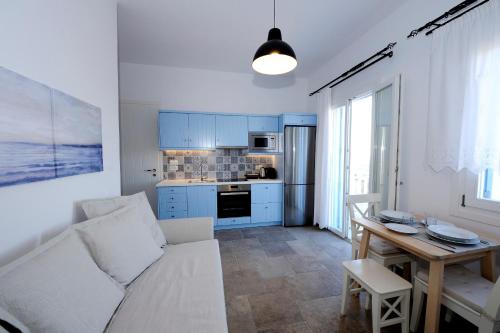 a living room with a white couch and a table at Stilvi Milos in Plaka Milou