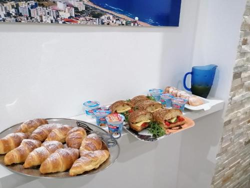 two plates of pastries and sandwiches on a table at B&B 36 Passi dal mare 2.0 in Trapani