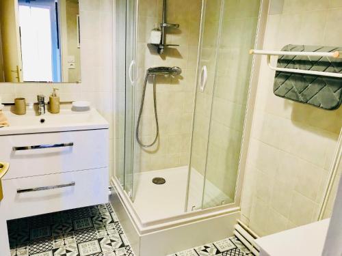 a bathroom with a shower and a sink at Le Foch in Ouistreham