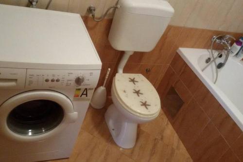 a bathroom with a toilet with stars on the seat at Apartment The View Costabella no.2 in Rijeka