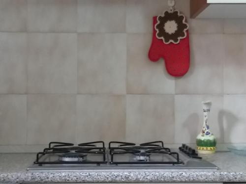 a stove top with a christmas stocking hanging on a wall at Villetta panoramica con vista mare in Carloforte