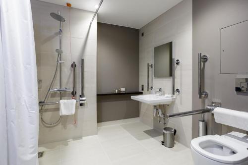 a bathroom with a shower and a toilet and a sink at Greenlands Hotel in Henley on Thames