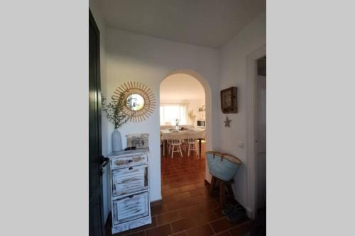 a hallway with a kitchen and a dining room at V. Lona: beautiful duplex with a stunning seaview in Es Mercadal