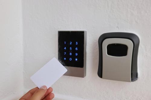 a person holding a white piece of paper next to a lightswitch at Beach Front Casa Elena in Hanioti